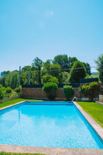 a swimming pool in the yard of a house at Just Like Home - Guarda Rios in Linhares