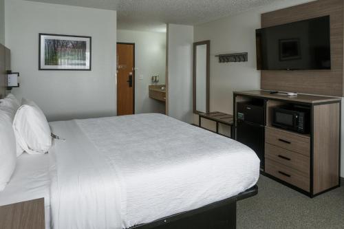 Ένα ή περισσότερα κρεβάτια σε δωμάτιο στο Hotel Pommier Chariton
