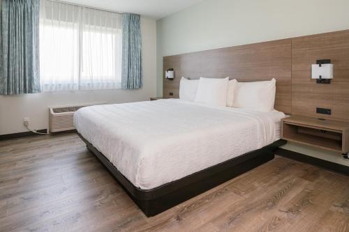 Ένα ή περισσότερα κρεβάτια σε δωμάτιο στο Hotel Pommier Chariton