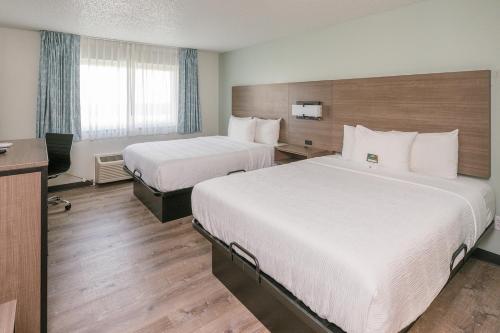 Ένα ή περισσότερα κρεβάτια σε δωμάτιο στο Hotel Pommier Chariton