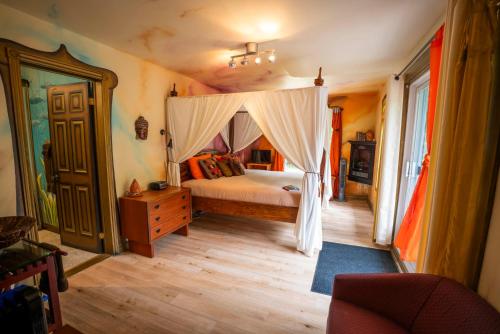 a bedroom with a bed with a canopy at Gîte Crystal Inn in Mont-Tremblant
