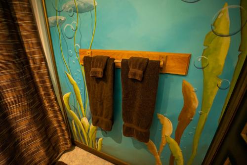 a bathroom with two brown towels hanging on a wall at Gîte Crystal Inn in Mont-Tremblant