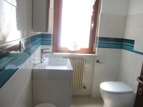 a bathroom with a sink and a toilet and a window at Breathtaking seaview in Grado-Beahost Rentals in Lido