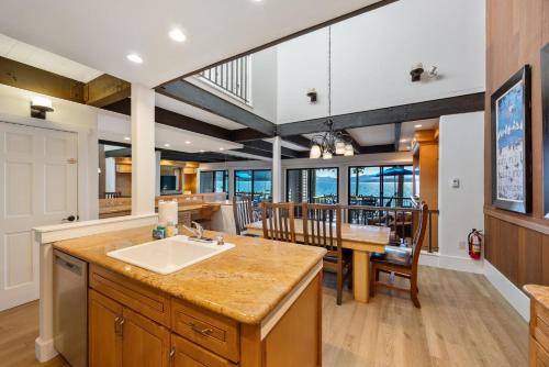 a kitchen with a sink and a dining room at Remodeled 4BR Lakefront with Exceptional Amenities in Kings Beach