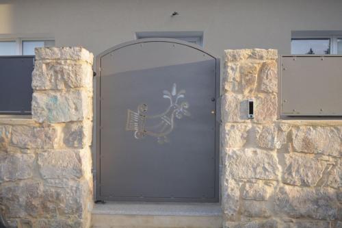 a metal door with a deer painted on it at Charming SantAntioco Apt with 2-Way Air Con in SantʼAntìoco