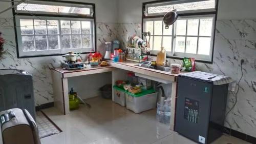 a small kitchen with a counter and a sink at Naufal Homestay in Yogyakarta
