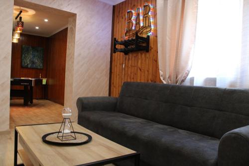 a living room with a couch and a coffee table at Maison privative SPA Jacuzzi Sauna Salle de jeux in Weitbruch