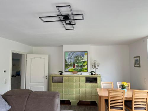 a living room with a couch and a chandelier at Ferienwohnung am Uniklinik Lübeck in Lübeck