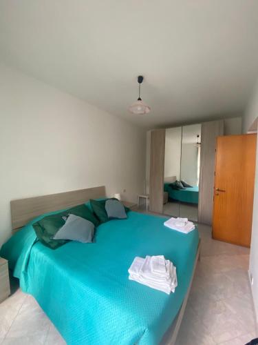 a bedroom with a blue bed with towels on it at Noor in Riomaggiore