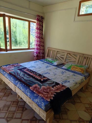 a large bed in a room with a table at Rishu Homestay in Chakrāta