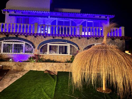a house with a roof with purple lights at VILLA COCO CALPE 10 pers gehele villa in 3 appartmenten in Calpe