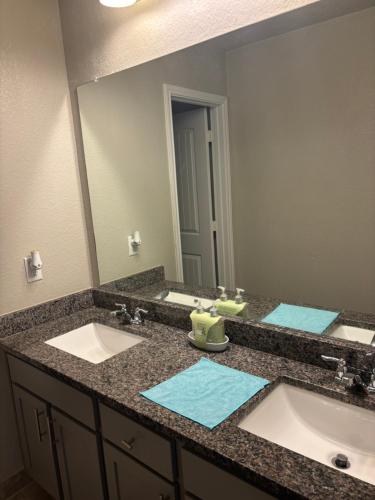 a bathroom with two sinks and a large mirror at Gayson Gardens Drive Richmond Texas USA in Richmond