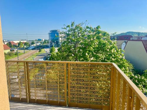 a wooden balcony with a view of a city at Modern Apartment with Balcony near SCS in Wiener Neudorf