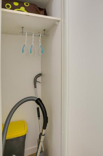 a bathroom with a hose hooked up to a wall at L'Explorer Rennes Métropole in Betton