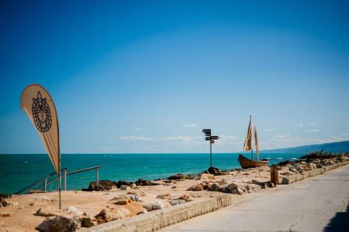 a beach with a sign next to the water at Cossara luxury villas - Adults Only in Balchik