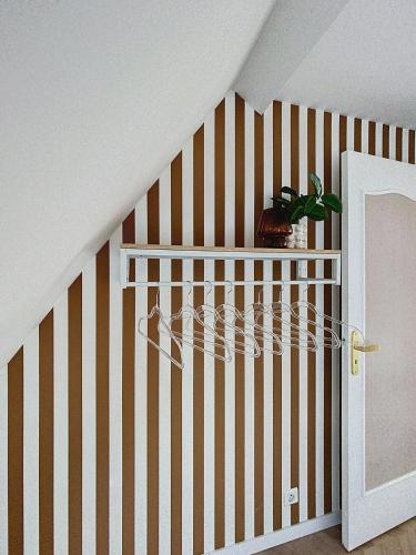 a room with a crib with a striped wall at L'escale du Val in Pléneuf-Val-André