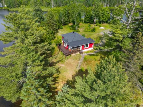 an aerial view of a house in the middle of trees at Ile privée unique - Islet Chouette in Saint Mathieu Du Parc