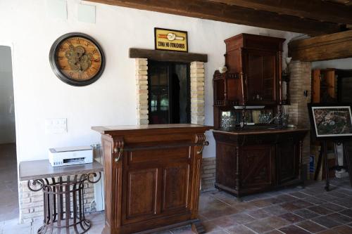 a room with a clock on the wall and a table at Resort Carpe Diem El Perelló in Perelló