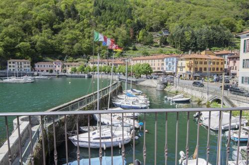 a group of boats are docked in a harbor at Architect s house in Dongo