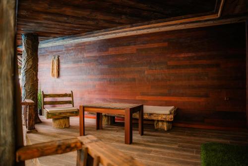 a bench and a table and a chair on a porch at Cossara luxury villas - Adults Only in Balchik