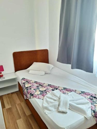 a small bedroom with a bed with towels on it at Chance Sarafovo in Burgas