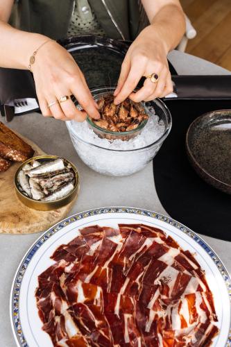 a person eating food in a bowl on a table at Boutique Hotel Azur in De Haan