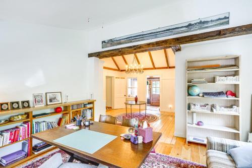 a living room with a table and a couch at 9 Mi to Dtwn Hudson Pet-Friendly Home with Pool in Craryville