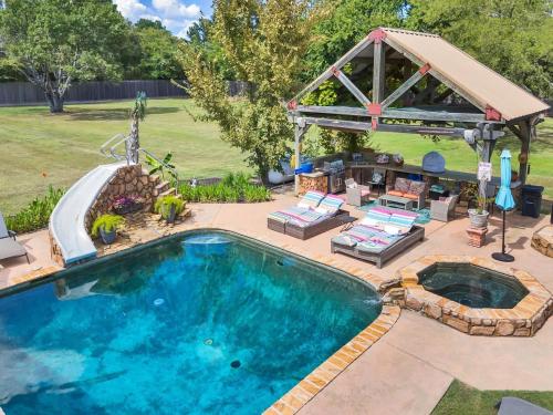 an outdoor pool with a gazebo and a swimming pool at The Tahitian in Canton