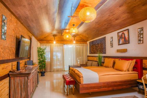 a bedroom with a bed and a tv in a room at Cossara luxury villas - Adults Only in Balchik