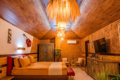 a bedroom with a bed and a couch in a room at Cossara luxury villas - Adults Only in Balchik