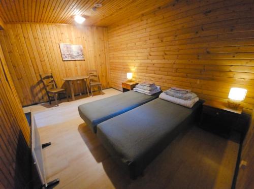 a bedroom with a bed and a wooden wall at Viitna Puhkekeskus in Viitna