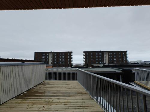 a walkway on a building with buildings in the background at Spacious Apartment for 6 with Sauna in Oulu