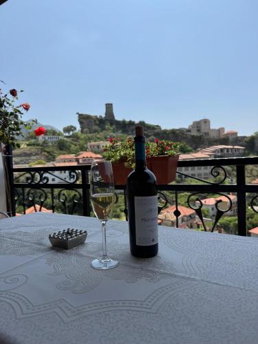 a bottle of wine sitting on a table with a glass at Villa Castriota in Krujë