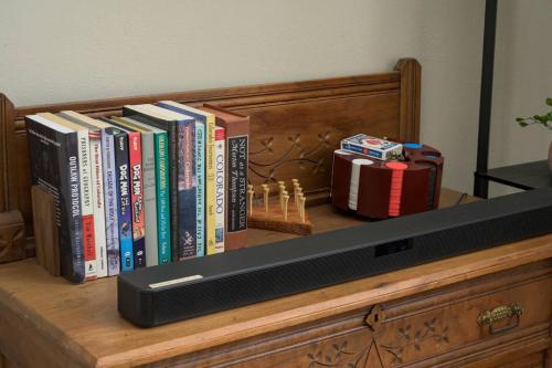 a shelf with books on top of a dresser at St Marys Glacier Retreat A Cozy Lakeside Escape in Idaho Springs
