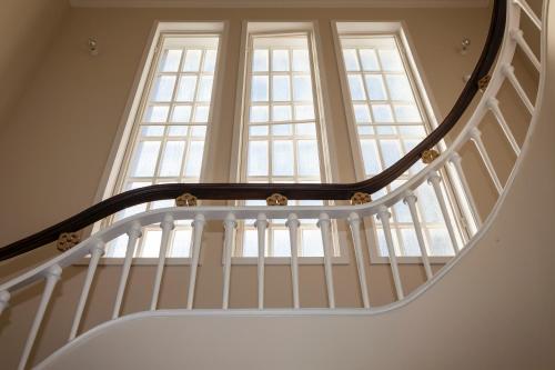 a spiral staircase with a large window at Casa Kala in Porto