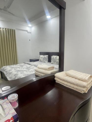 a bedroom with a bed and a mirror on a desk at Spacious 2 bedroom & maid room in Jazīrat Umm ash Shajar