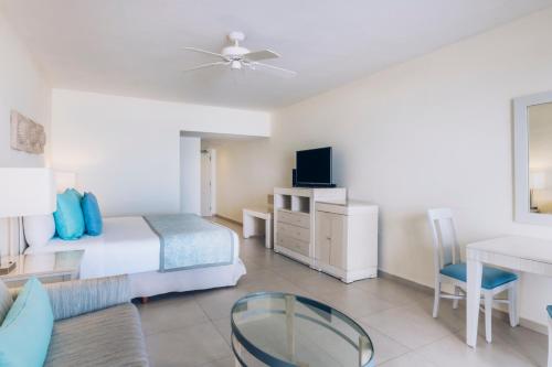 a hotel room with a bed and a table at Iberostar Selection Cancun - All Inclusive in Cancún