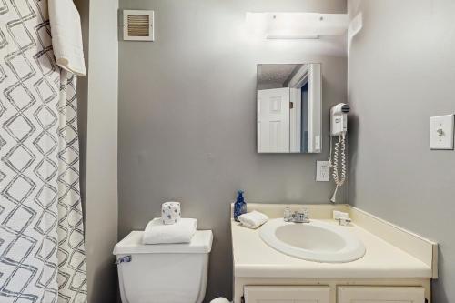 a bathroom with a sink and a toilet and a mirror at 303 Sugar Top Dr #2901 in Sugar Mountain