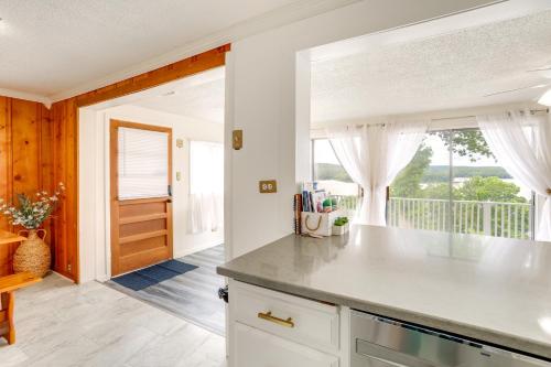 a kitchen with a counter and a view of a balcony at Norfork Lake Views Home with Deck in Henderson in Henderson