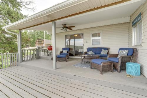 a porch with chairs and a table and a fan at Norfork Lake Views Home with Deck in Henderson in Henderson