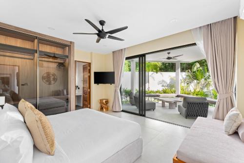 a bedroom with a bed and a living room at Samudo 3br Tropical Haven in Bophut