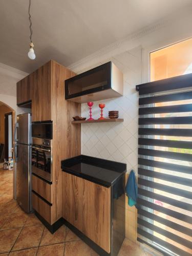 a kitchen with a stove and a refrigerator at Kalaat El Mansouria in Mansouria