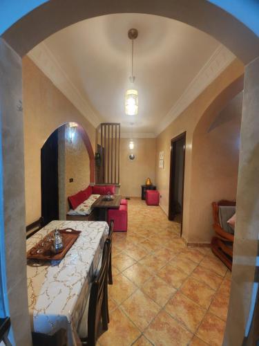 a living room with a table and a couch at Kalaat El Mansouria in Mansouria