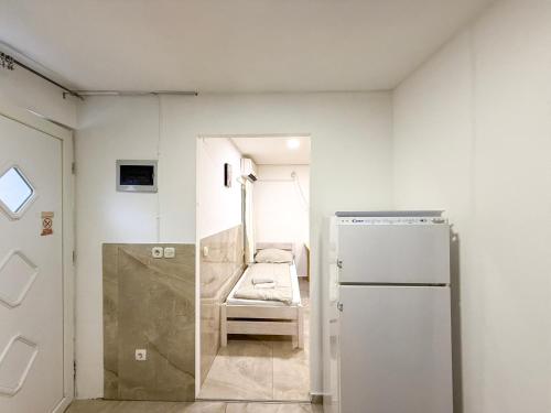 a small room with a refrigerator and a chair at Lighthouse in Vodice