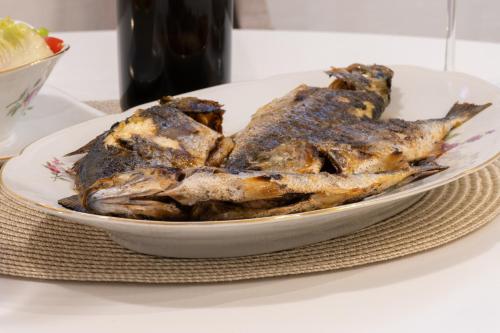 a white bowl of food on a table at Pupi Studio Apartment Trogir in Trogir