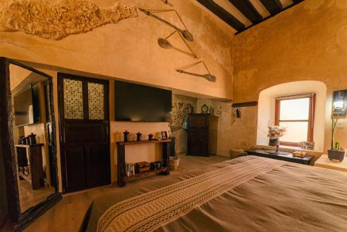 a large room with a large bed and a television at Hotel Boutique Casa Lanz XVII in Campeche