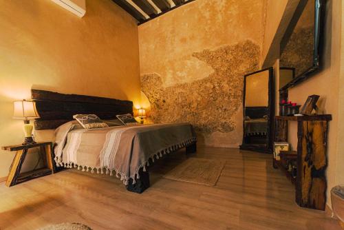 a bedroom with a bed and a mirror in it at Hotel Boutique Casa Lanz XVII in Campeche