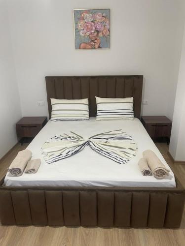 a bed with a bow tie on top of it at Seliano Residence in Velipojë