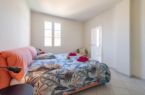 a bedroom with a bed with a colorful comforter at Beaulieu Garden Apartment in Beaulieu-sur-Mer