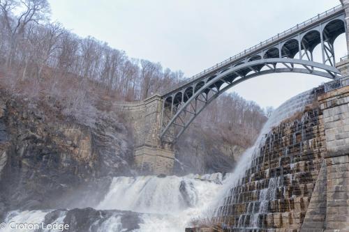 a bridge over a waterfall with a waterfall at Croton Nook - Cozy Getaway in Croton-on-Hudson